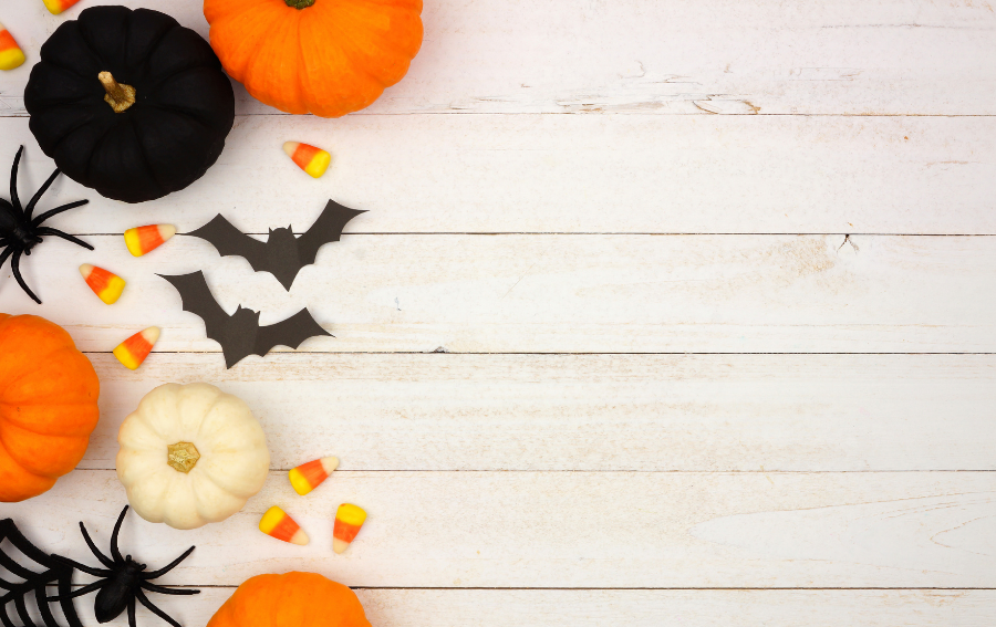 Black and orange pumpkins with bats and candy corn