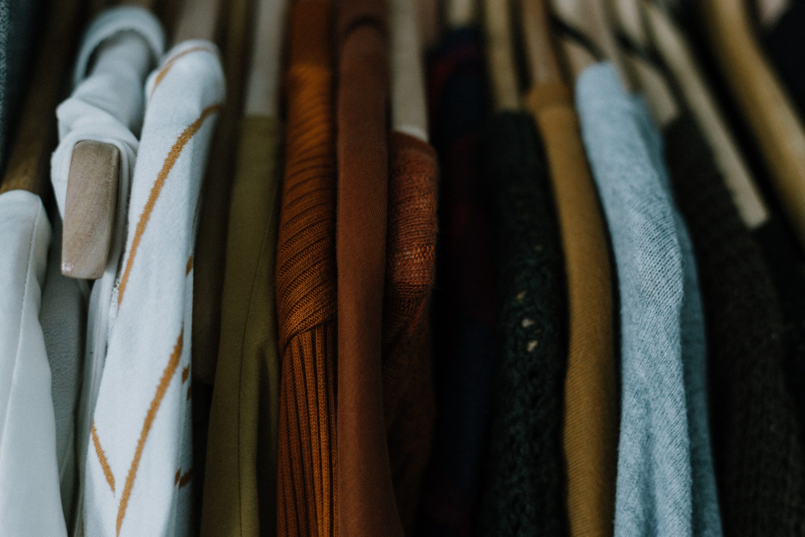 Sweaters hanging in closet