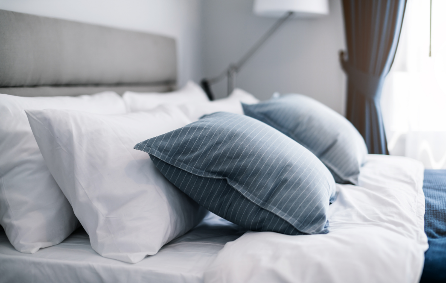 Guest room bed made with blue pillows