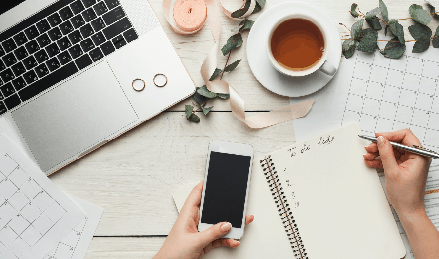 Lady holding phone with computer and flower