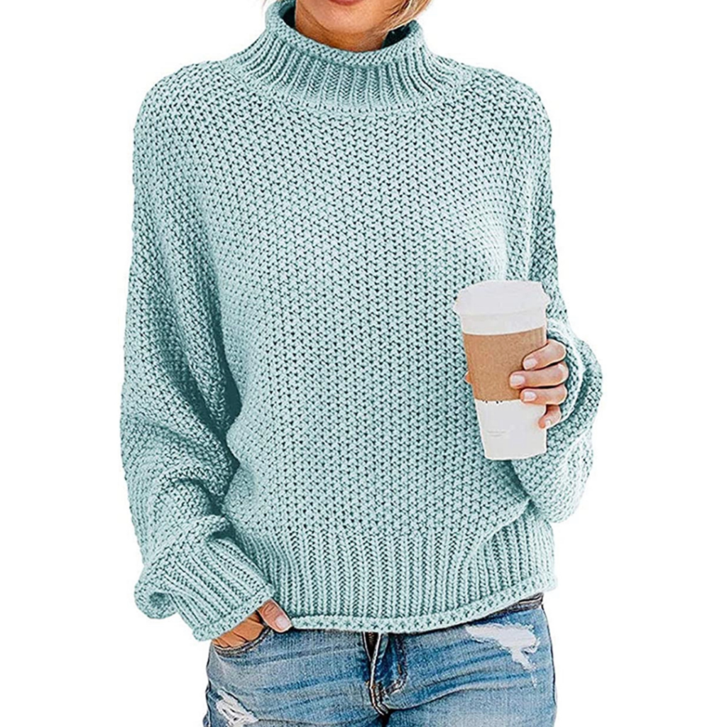 Woman wearing blue sweater holding coffee