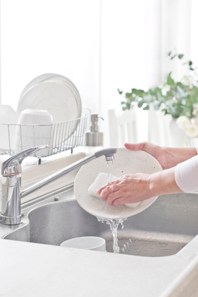 Washing dishes in sink