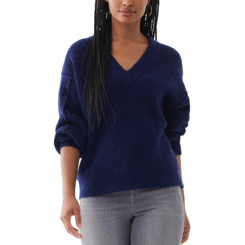 A woman wearing a dark blue sweater