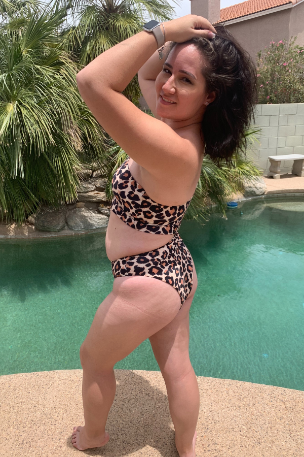 Standing near pool in leopard bathing suit, holding up my hair