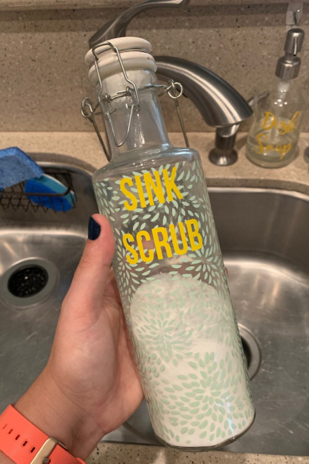 Holding a blue and white bottle of sink scrub