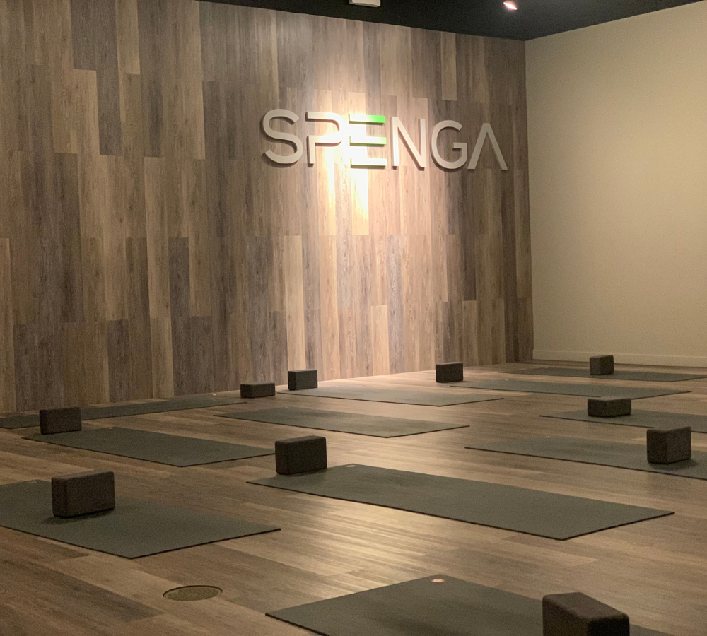 SPENGA Wall with large letters that spell spenga and yoga mats with blocks