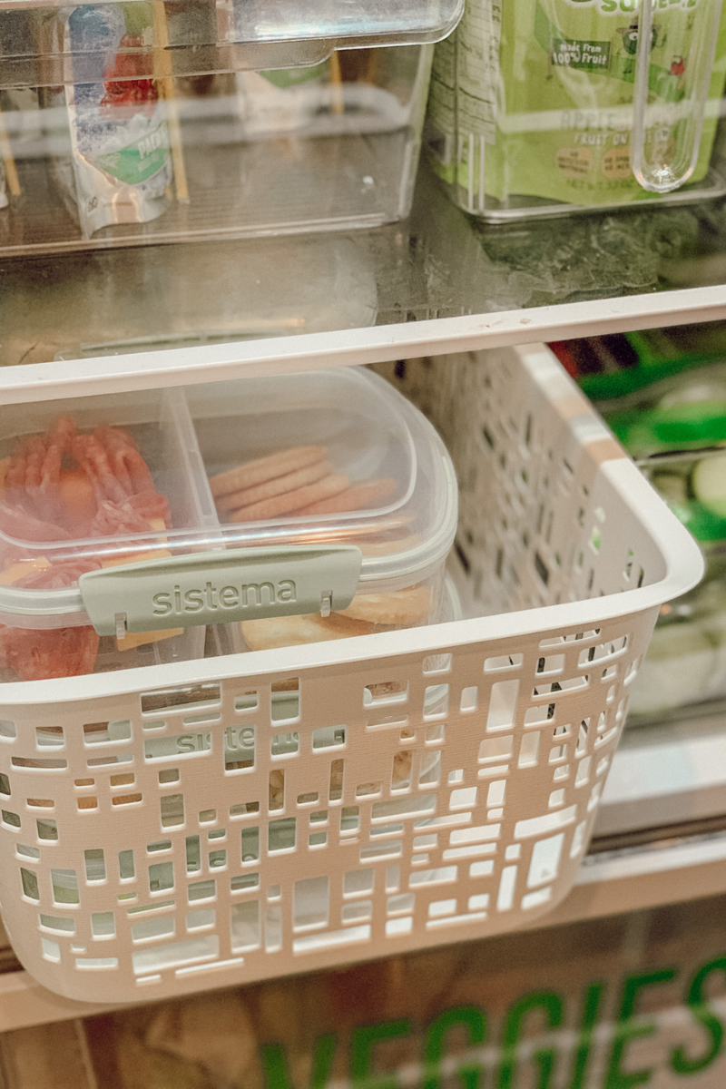 Fridge shelves with ranch cups and apple sauce