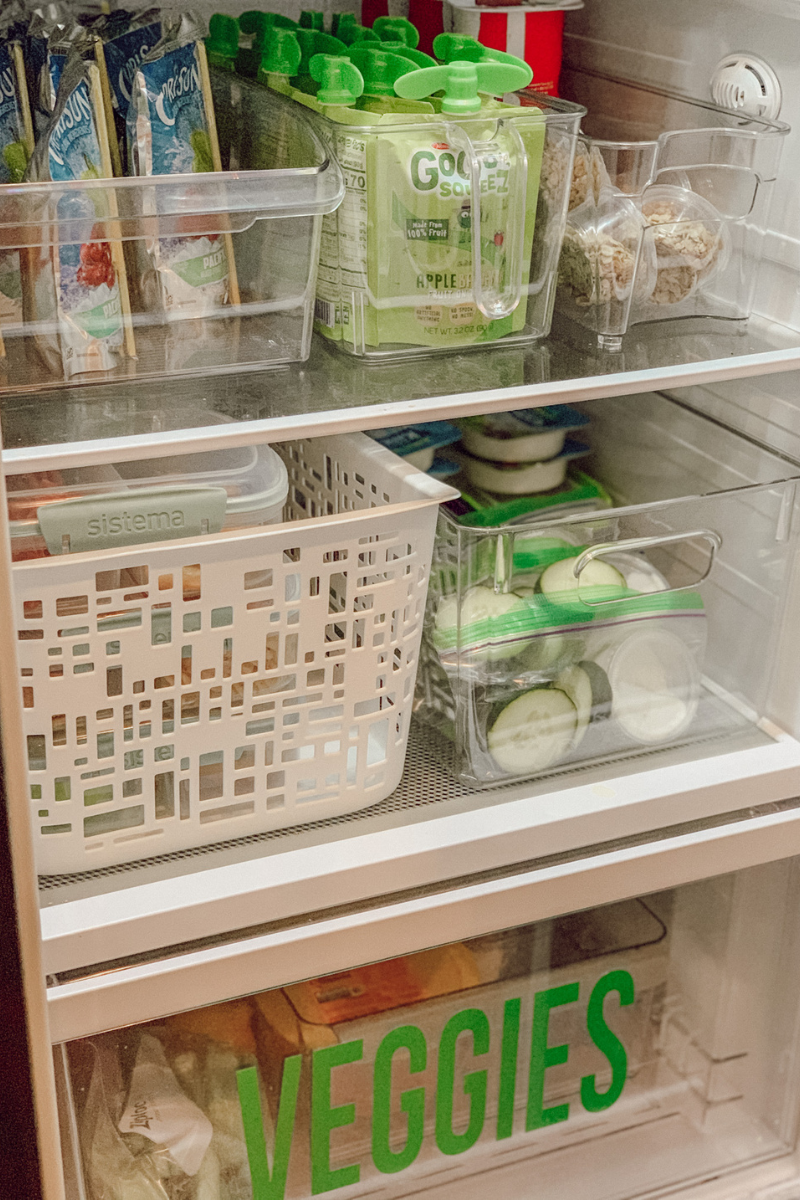 Fridge shelves with ranch cups and apple sauce