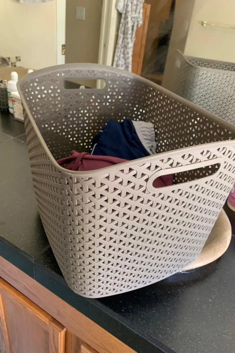 Brown plastic basket on a bathroom counter