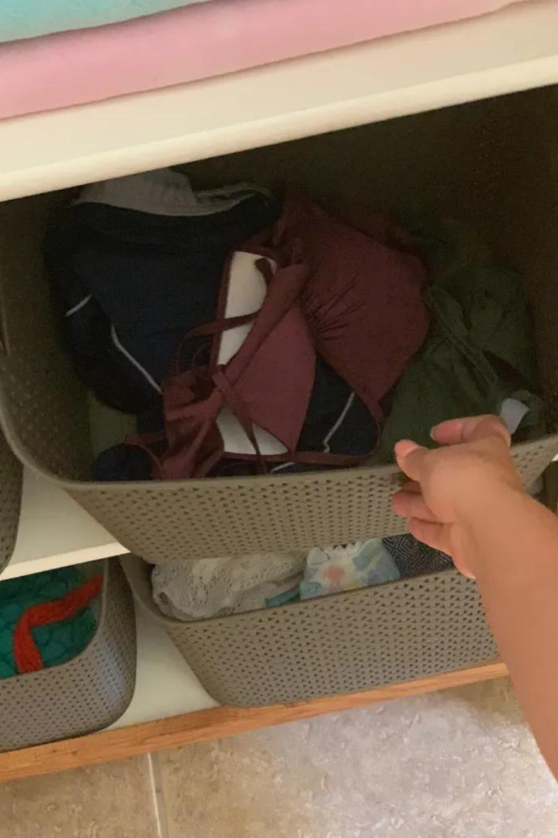 Brown plastic basket being pushed onto a shelf